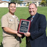 navy divorce lawyer and client with award