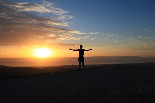 client of business valuation lawyer celebrating good news with arms stretched out