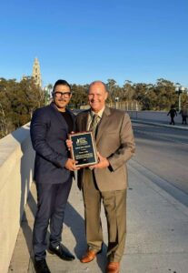 business valuation lawyer presenting award to client