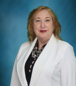 female men's equal rights lawyer in a white blazer