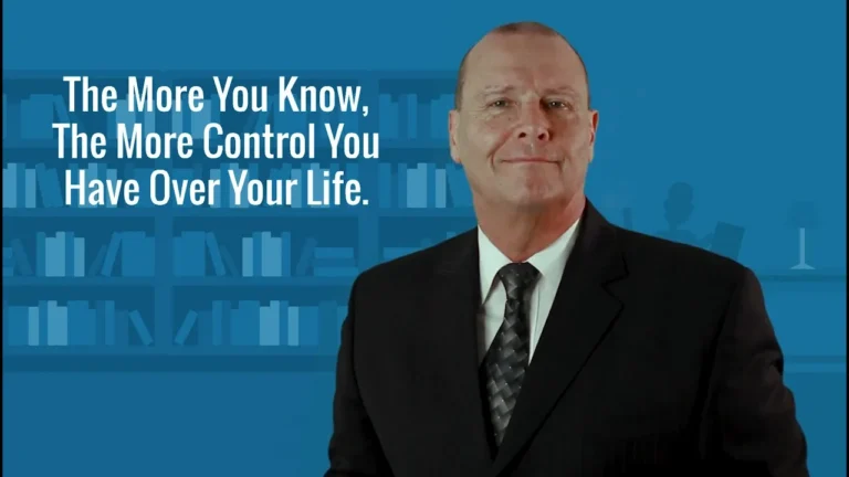 Professional man in black suit and tie with motivational text and blue bookshelf background.