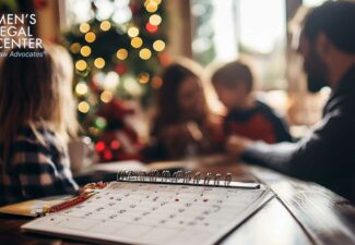 A family discussing holiday plans with a calendar on the table.