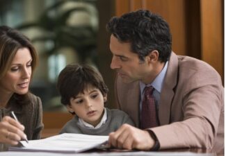 A lawyer and father discussing child custody with a lawyer in a professional office setting.
