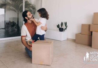 Dad and young child packing moving boxes together at home