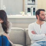 Husband and wife in an argument on their living room couch