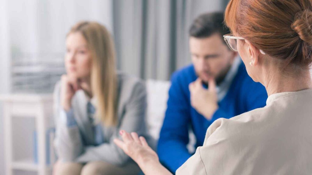Divorcing couple speaking with a mediator.