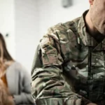 Man in military uniform and his partner having a serious disagreement at home