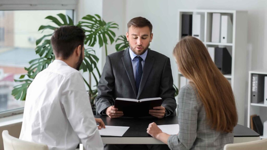  A couple sitting across from a lawyer in an office