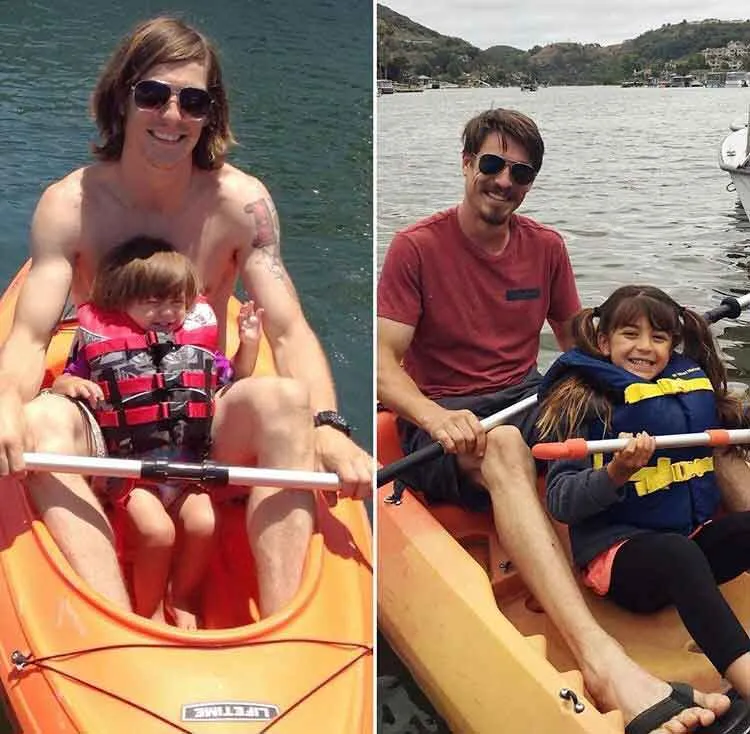 Two men wearing sunglasses kayaking with young girls in life jackets on a lake.