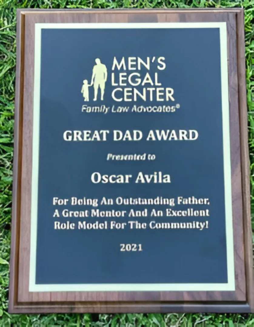 Plaque from Men's Legal Center awarding Oscar Avila the 2021 Great Dad Award for outstanding fatherhood and community mentorship.